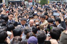 Crowds of people looking for the newspaper announcing the decision on the new era name, "2045.